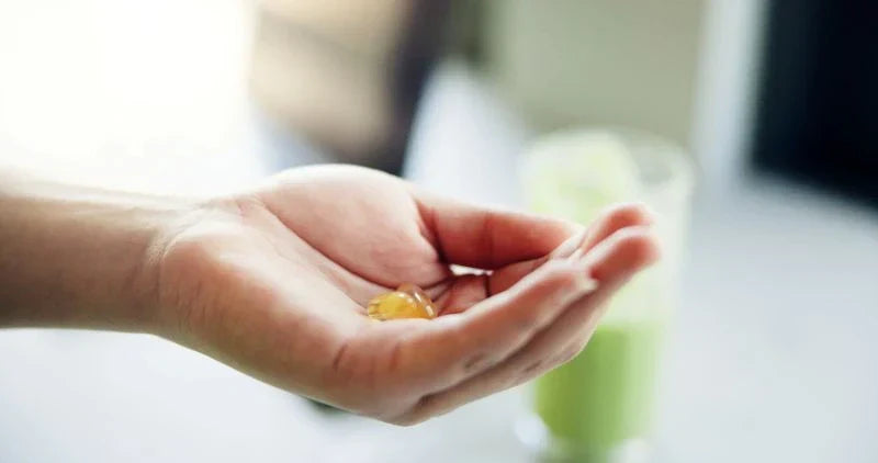 A woman pouring a smoothie, emphasizing the importance of a healthy diet and gut health supplements for optimal digestive wellness.